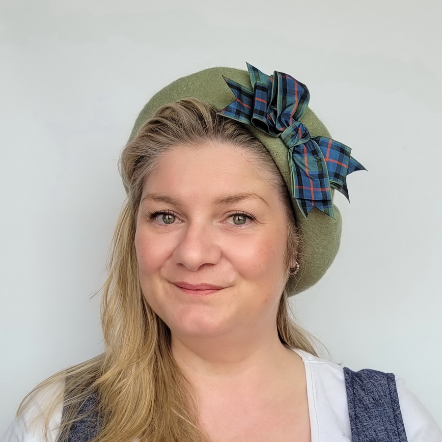 Sage Green Beret with Flower of Scotland Tartan Ribbon Bow worn by a white woman in her 40s with long blonde hair