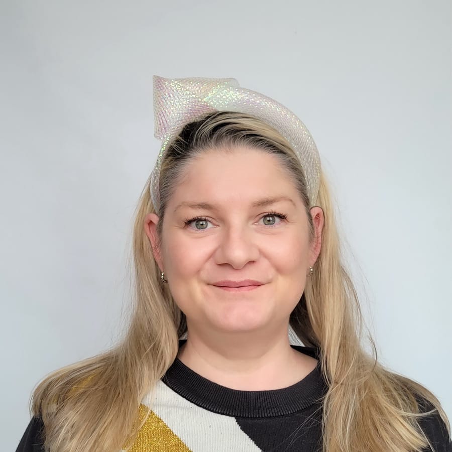 Iridescent Pearl Crinoline Knot Headband worn by a white women in her 40s with long blonde hair