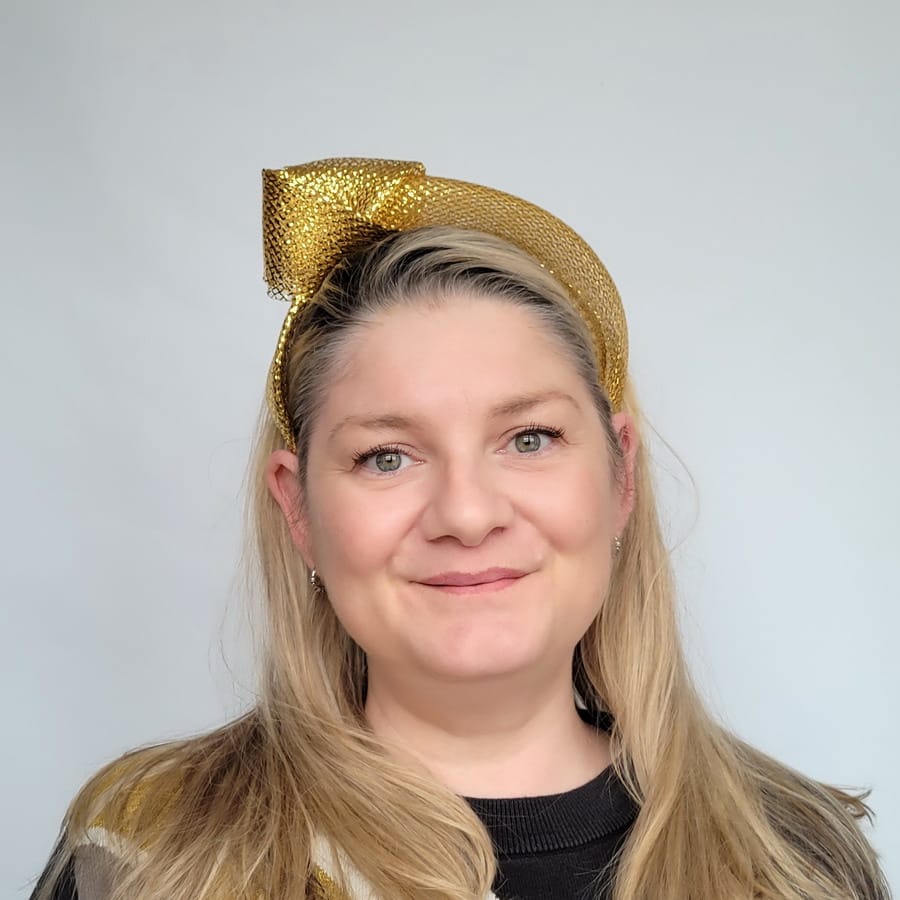 Metallic Gold Crinoline Knot Headband worn by a white women in her 40s with long blonde hair